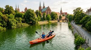 A high-angle, professional editorial shot of a couple paddling a bright rental kayak through the cal