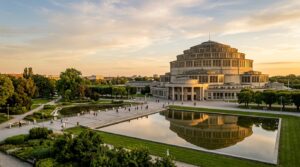 A stunning, professional architectural wide-angle shot of the Centennial Hall in Wrocław under a sof