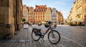 A high-angle, professional editorial shot of a sleek Nextbike city rental bike parked on a vibrant,