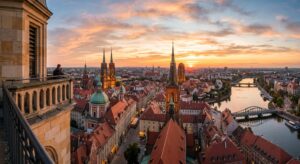 A professional editorial photograph capturing a breathtaking sunset view from the historic tower of